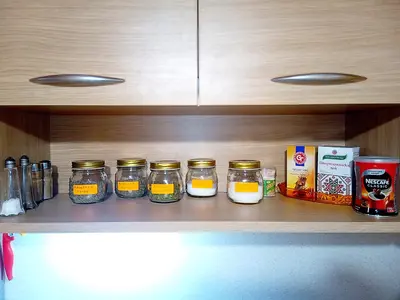 a shelf with four jars of food on it at 