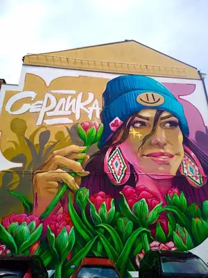 a mural of a woman painted on the side of a building at 