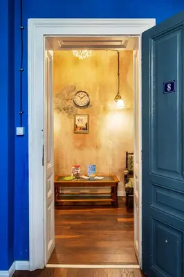 a hallway with a table and a clock on the wall at The Green Bar House in Sofia