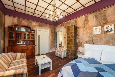 a bedroom with a bed and a couch and a table at The Green Bar House in Sofia