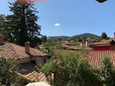 a view of a village with roofs and trees at Borimechkova Kashta in Koprivshtitsa