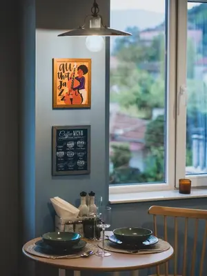a table with two plates on it next to a window at Stylish 1BD - Free Private Garage in Plovdiv