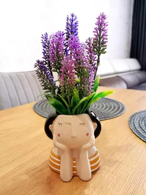 a vase filled with purple flowers on a table at Viva 3 Grand monastery in Pamporovo