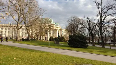 a white building with a statue in front of it at Bijoux Apt in the heart of Sofia in Sofia