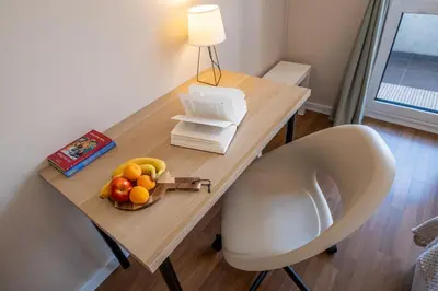 a desk with a bowl of fruit and a chair at City Oasis: Stylish Retreat in the Heart of Sofia in Sofia
