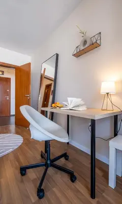 a desk with a white chair and a mirror at City Oasis: Stylish Retreat in the Heart of Sofia in Sofia