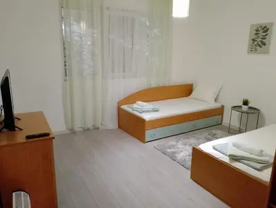 a small room with a bed and a desk at Apartment Danilia in Sandanski