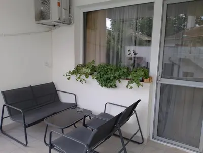 a patio with two chairs and a table and a window at Apartment Danilia in Sandanski