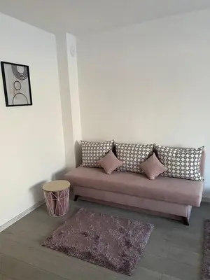a living room with a couch and a rug at Apartment Danilia in Sandanski