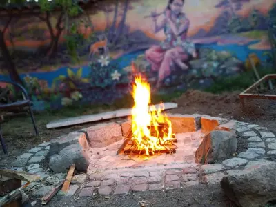 a fire pit with flames in the middle of it at Villa 