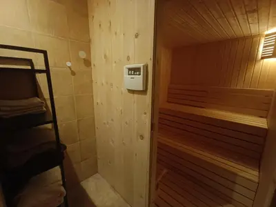 a small bathroom with a shower and a bed at Villa 