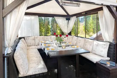 a dining room with a table and a couch at Face Hotel in Sofia