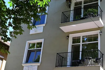 a building with balconies on the side of it at The House - Central Boutique Apartments in Kyustendil