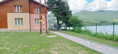 a house on the side of a body of water at Къща за гости Джамбазови in Sarnitsa