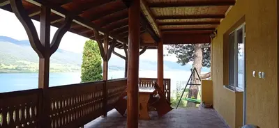a porch of a house with a view of the water at Къща за гости Джамбазови in Sarnitsa