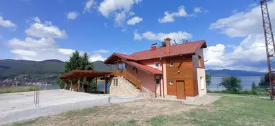 a small house with a red roof at Къща за гости Джамбазови in Sarnitsa