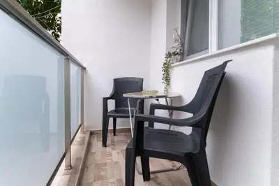 a small table and chairs on a balcony at Heart of the City 2-Bedroom Apartment in Plovdiv