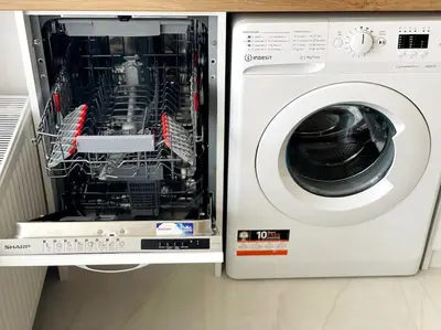 a washing machine with its door open in a kitchen at Katerina Apartments in Velingrad