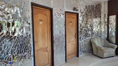a hallway with two wooden doors and a chair at ТРАКАРТ-ПАРК in Plovdiv