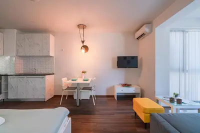 a small living room with a table and a couch at Bright Studio in the City Center in Sofia