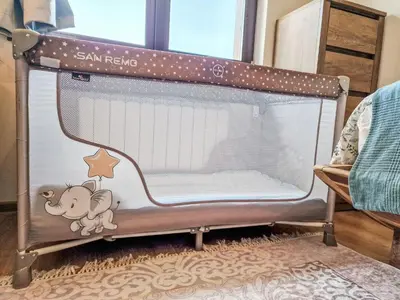 a baby crib with a star and a cow on it at Pastels - 2BD in Trinity Bansko with underground parking by Flat Mаnager in Bansko