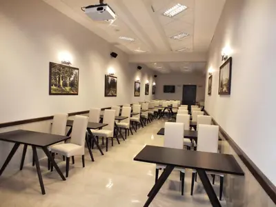 a dining room with tables and white chairs at Hotel Dragalevtsi in Sofia