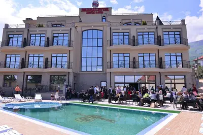 a group of people sitting in front of a building at Hotel Dragalevtsi in Sofia