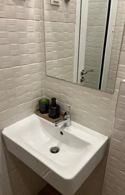 a white sink in a bathroom with a mirror at Bunaya Sofia in Sofia