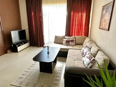 a living room with a couch and a table at Diana’s place in Sandanski