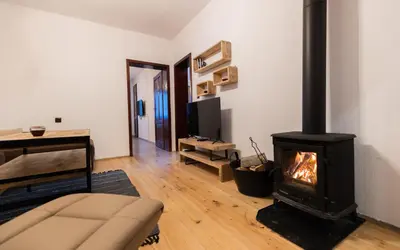 a living room with a fireplace and a couch at Къща за гости Константин и Елена - гр. Девин in Devin