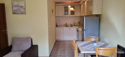 a kitchen and dining room with a table and chairs at Bojurland, Bansko, Bulgaria in Bansko
