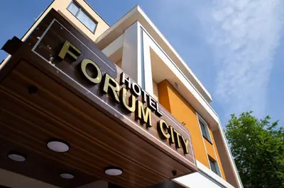 a building with a sign for a convention center at Hotel Forum City in Pazardzhik