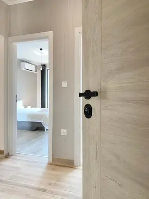 a door leading to a bedroom with a bed at Private Apartment for 4 Guests and Parking in Plovdiv