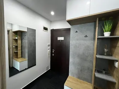 a room with a hallway with a door and a shelf at Blue & Gold Stylish Apartment in Sofia