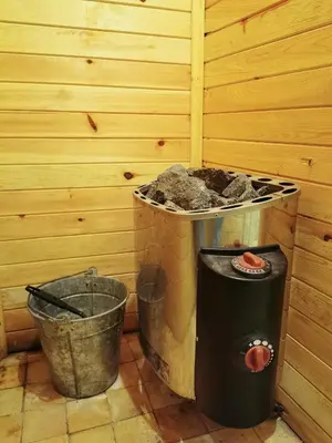 a corner of a room with a trash can and a bucket at Комплекс Петлето in Smolyan