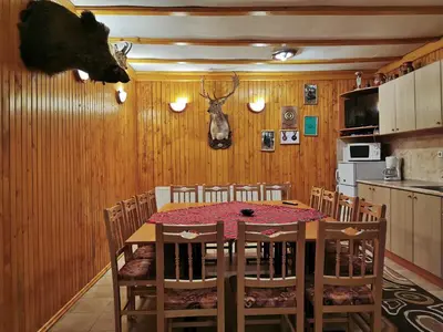 a dining room with a table and chairs at Комплекс Петлето in Smolyan