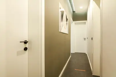 a hallway with a white door and a gray floor at Viral 2 BR Photo Studio Loft in Sofia