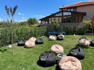a group of bags on the grass in a yard at Hotel BLISS Sofia Airport Self Check In in Kazichene