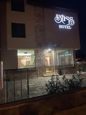 a sign for a sick hotel at night at Hotel BLISS Sofia Airport Self Check In in Kazichene