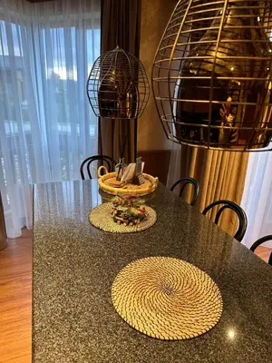 a dining room table with a black counter top at Pirin Golf Hotel&Spa Apartment 17 - private luxury apartment in Razlog