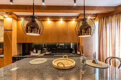 a kitchen with two pendant lights and a counter at Pirin Golf Hotel&Spa Apartment 17 - private luxury apartment in Razlog