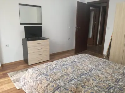 a bedroom with a bed and a dresser and a television at Fashion Apartments in Sandanski
