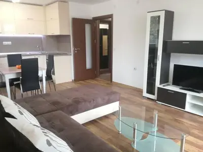 a living room with a couch and a glass table at Fashion Apartments in Sandanski