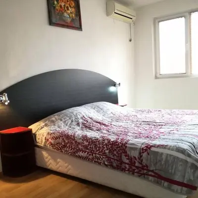 a bedroom with a bed in a room with a window at Fashion Apartments in Sandanski