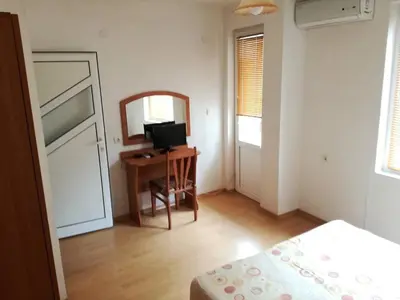 a bedroom with a bed and a desk and a mirror at Fashion Apartments in Sandanski