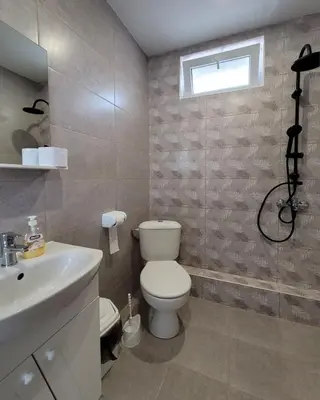 a bathroom with a toilet and a sink at Вила Виктория in Chekhlare