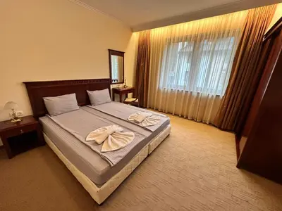 a bedroom with a bed with two towels on it at Downtown apartments in Bansko