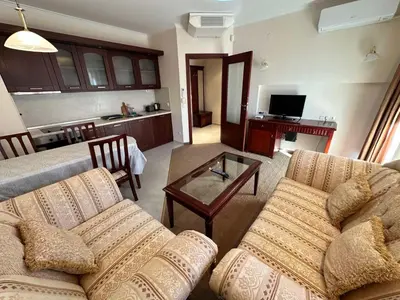 a living room with a couch and a table at Downtown apartments in Bansko