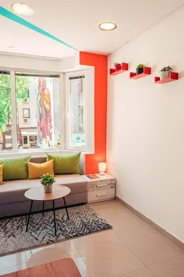 a living room with a couch and a table at BohoBox Studios in Plovdiv
