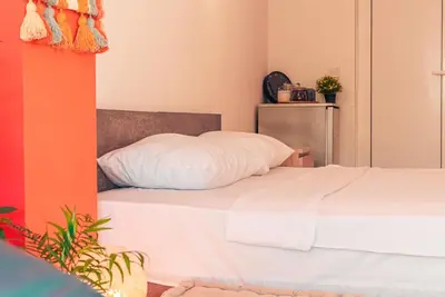 a bedroom with two beds with white pillows at BohoBox Studios in Plovdiv